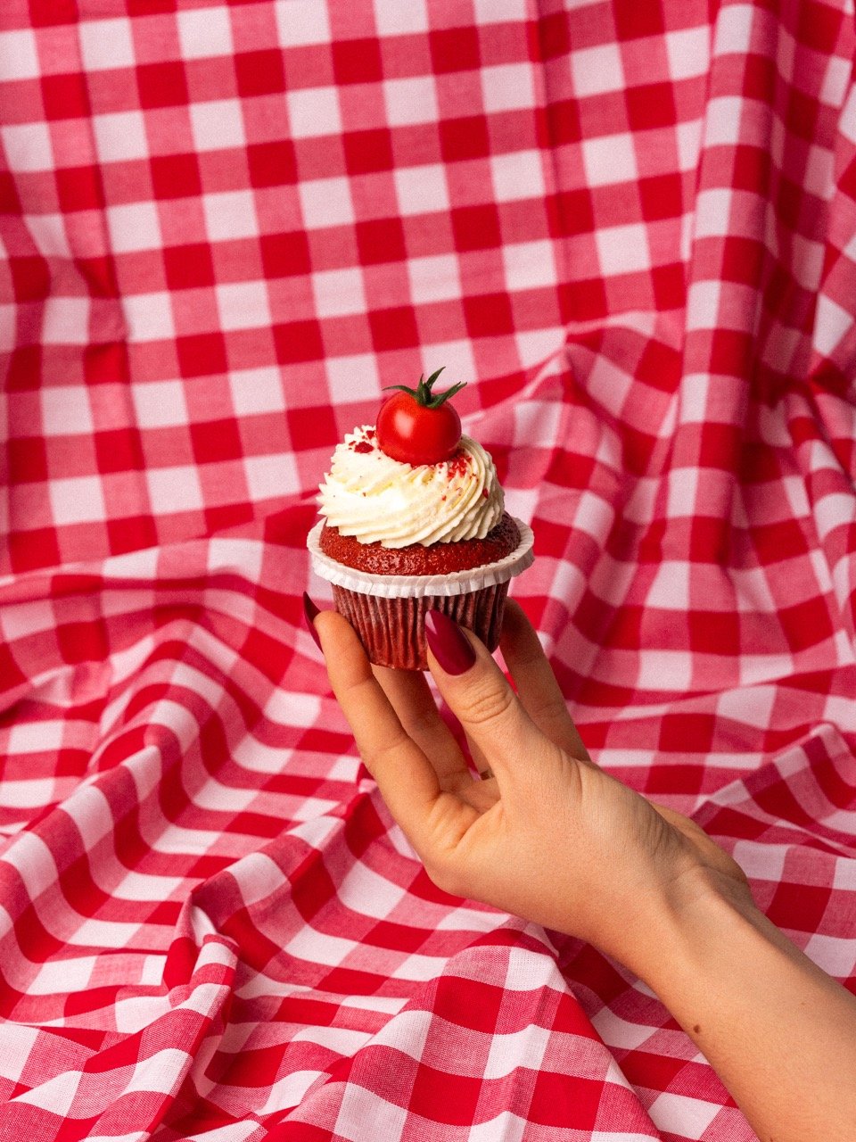 Eine Hand hält einen Cupcake